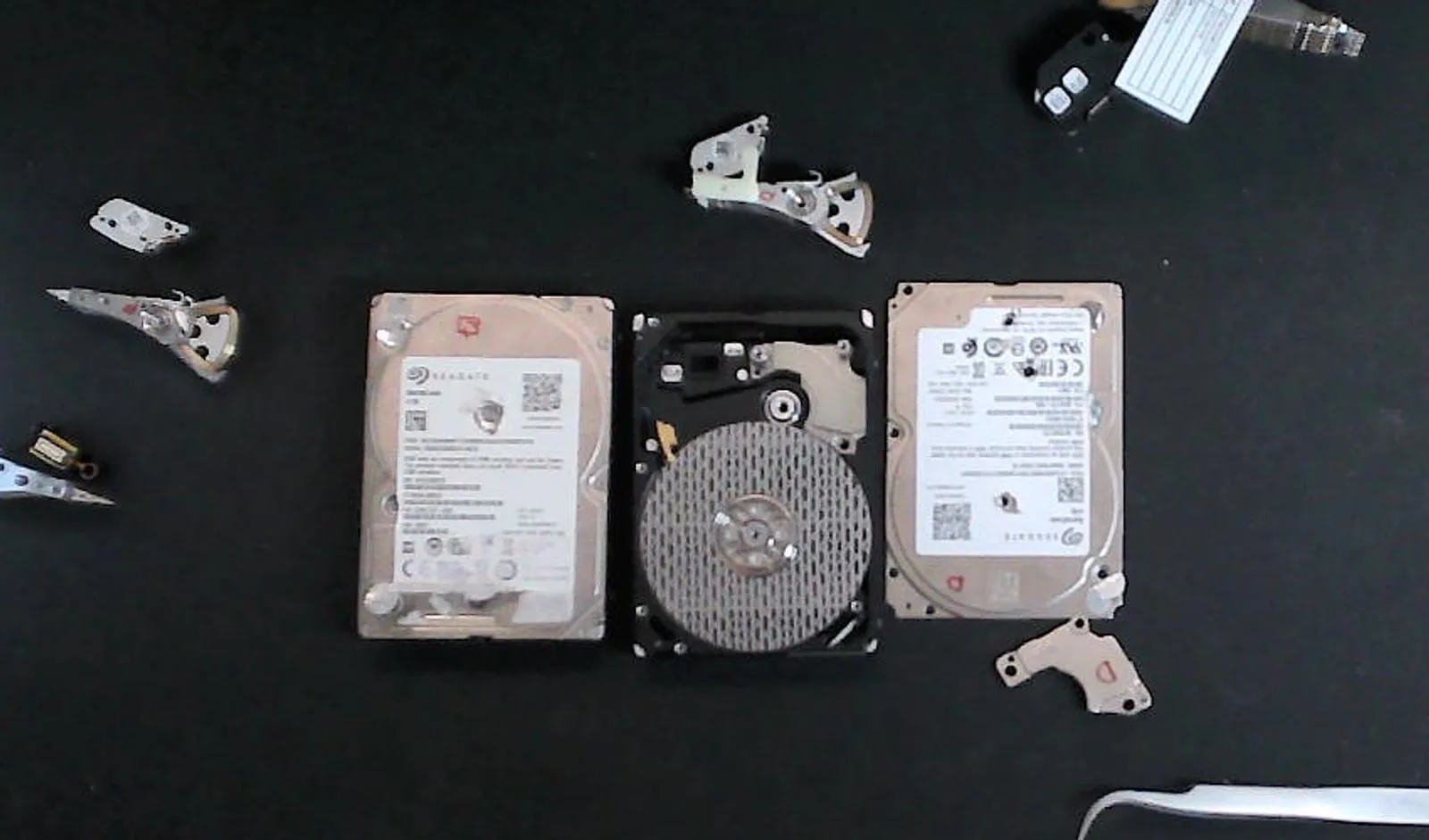 Failed hard drive positioned with donor drives and compatible head assemblies