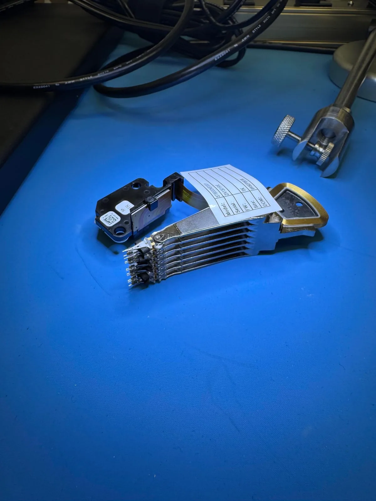 Donor hard drive head assembly prepared for controlled recovery work at the clean bench